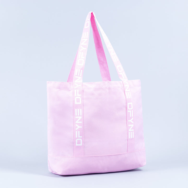 Light pink tote bag with logo handle tape and front panel seam detail.