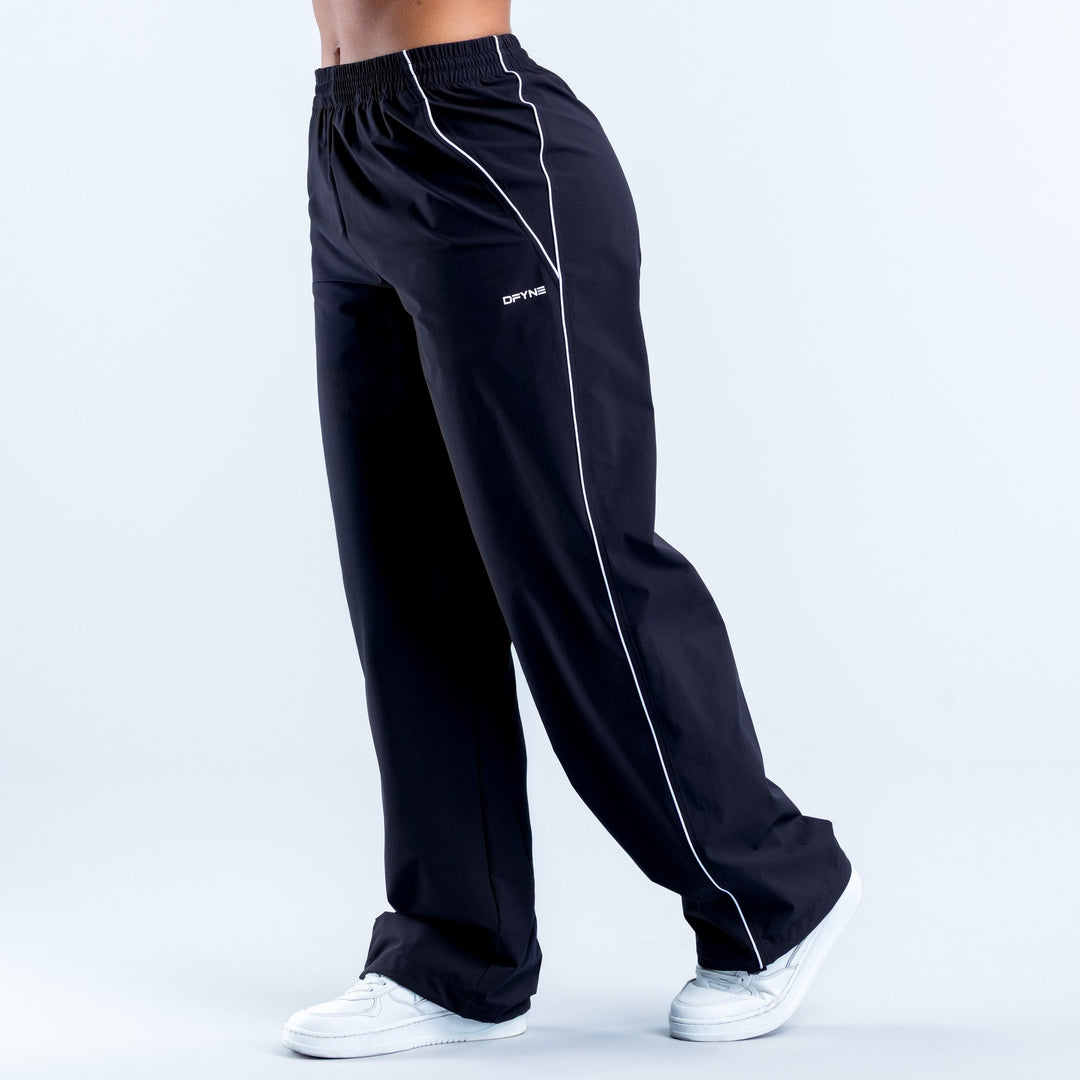 Men's dark track pants with elastic waist and white side stripe, tapered leg