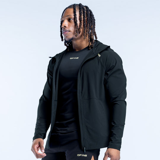 Dark hooded jacket with zip front and stand collar, side view