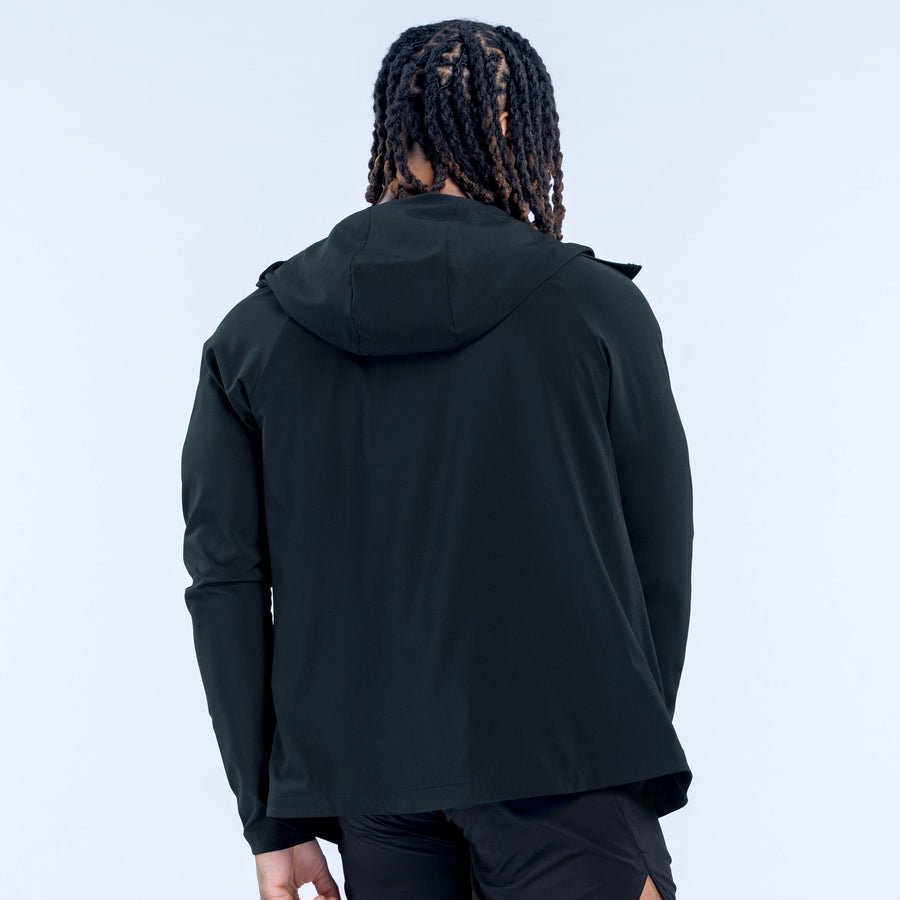 Back view of Unbound jacket, dark hooded windbreaker with zip front