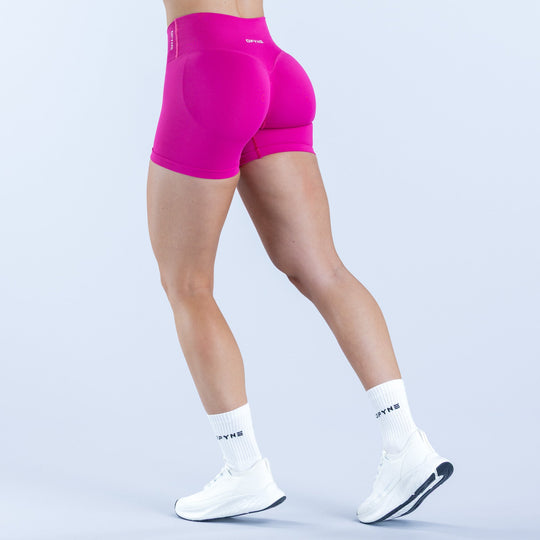 Women's 4.5-inch magenta active shorts, side view with contoured rear